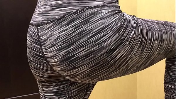 Cute boy trying on leggings in dressing room