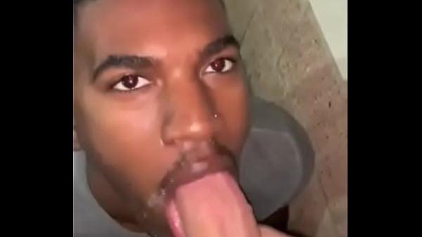 Black jock gives a sloppy blowjob to his white teammate after the game