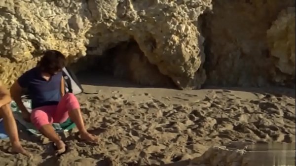 Two gay friends stroking at the beach